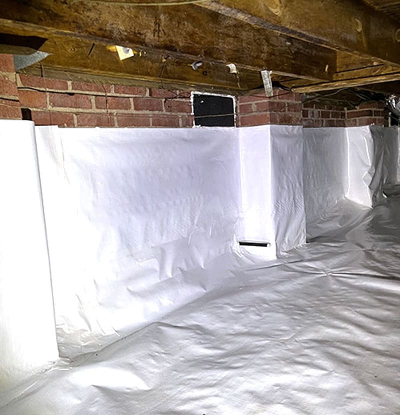 A lined crawl space with a closed vent opening above the wall liner