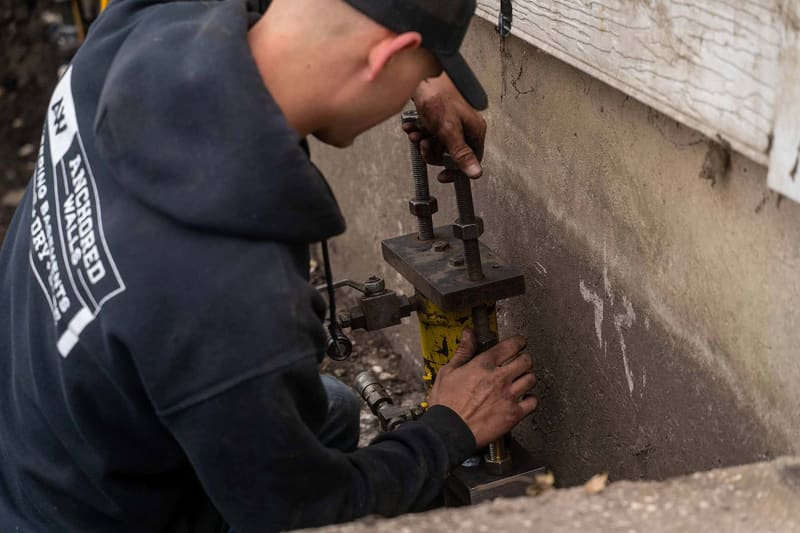 An Anchored Walls foundation repair technician