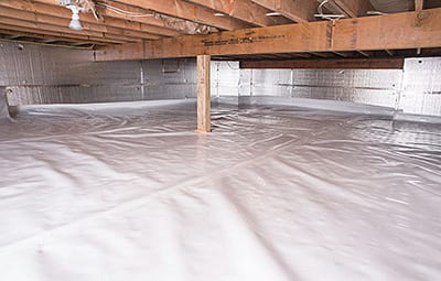 Clean encapsulated crawl space with a white vapor barrier on the floor and walls