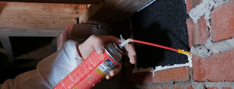 Sealing a crawl space vent opening with spray foam