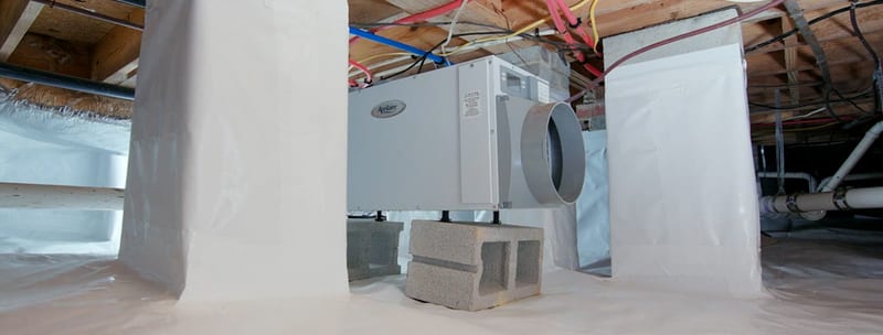 Dehumidifier in an encapsulated crawl space with wrapped support piers