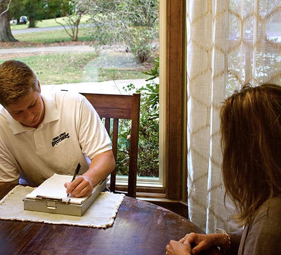 A specialist reviewing recommendations at a homeowner’s table