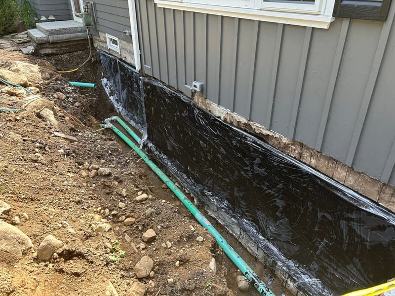 A drainage trench dug along a home’s foundation