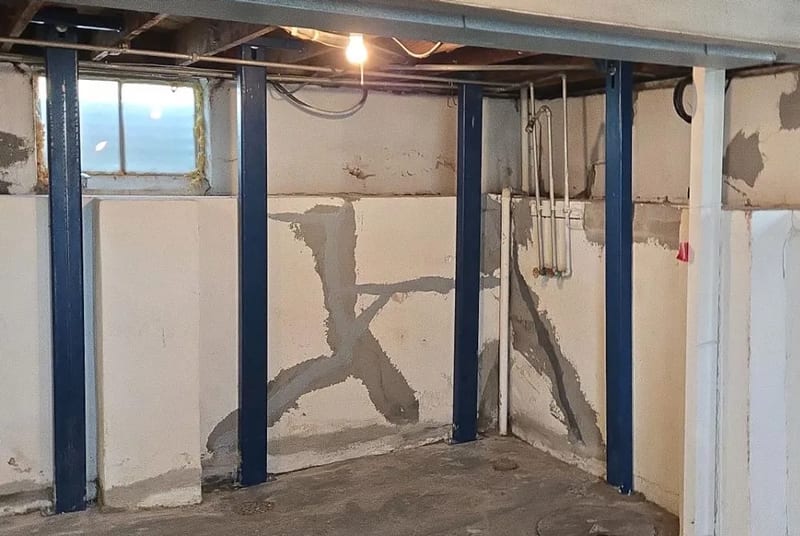 Steel braces supporting a basement wall