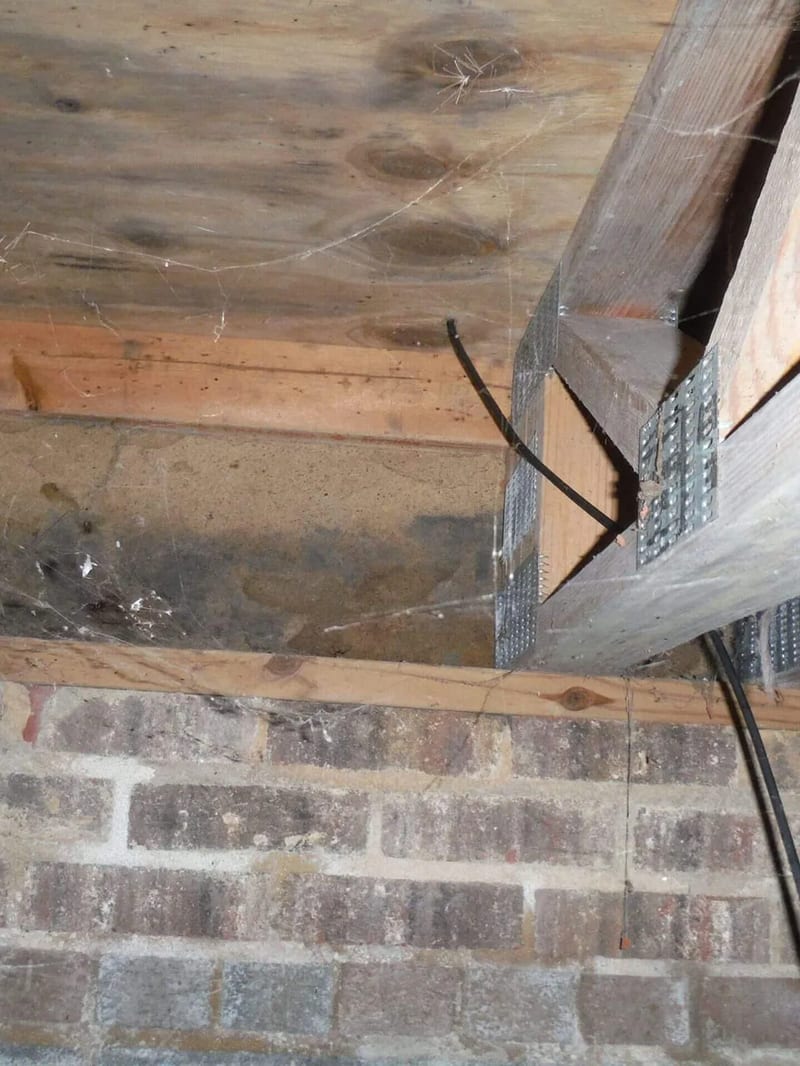 Deteriorated framing above a crawl space wall