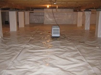 A sealed crawl space with a vapor barrier and dehumidifier