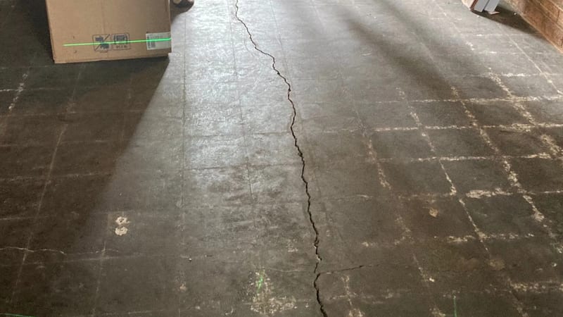 A crack extending across a basement concrete floor